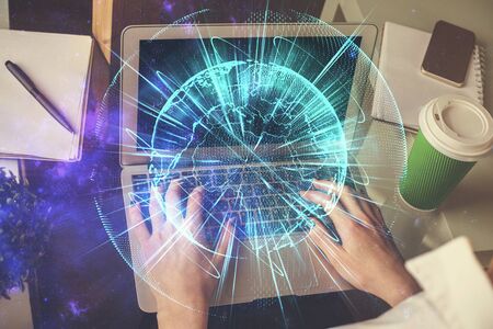 Double exposure of woman hands typing on computer and business theme hologram drawing. Success concept.の写真素材