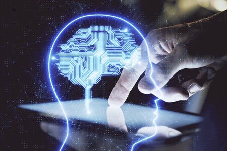 Double exposure of mans hand holding and using a digital device and brain hologram drawing. Data...