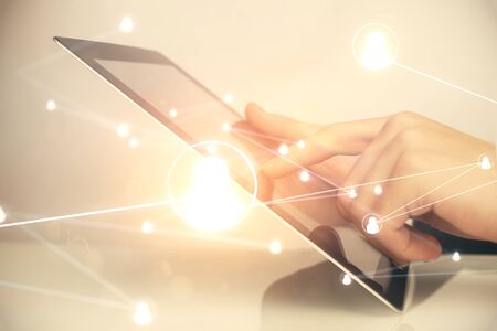 Double exposure of mans hands holding and using a phone and social network theme drawing.