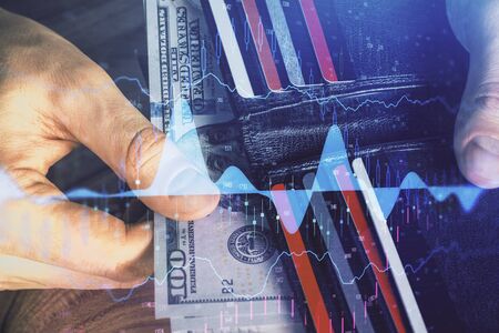 Multi exposure of forex graph drawing hologram and USA dollars bills and man hands. Technical...
