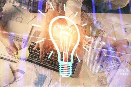 Double exposure of man and woman working together and bulb drawing. Computer background. Top View. Idea concept.の写真素材