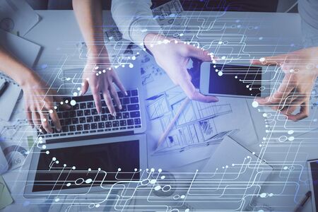 Double exposure of man and woman working together and data theme hologram drawing. Computer...