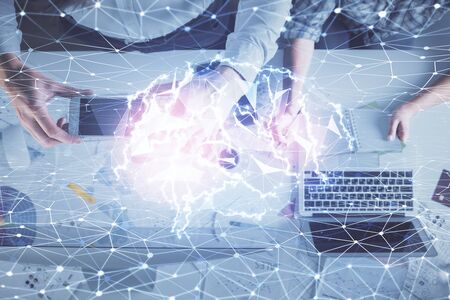 Double exposure of man and woman working together and human brain hologram drawing. Brainstorm...