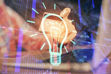 Double exposure of man hands holding a credit card and bulb drawing. Idea E-commerce concept.の写真素材