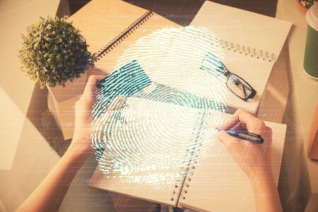 Multi exposure of woman on-line shopping holding a credit card and finger print drawing. Security concept.の写真素材