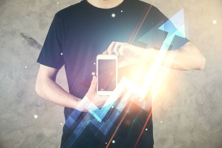 Double exposure of mans hands holding and using a digital device and arrows hologram drawing. Success concept.の写真素材