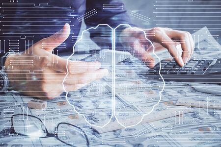 Double exposure of mans hand holding and using a digital device and brain hologram drawing. Data...