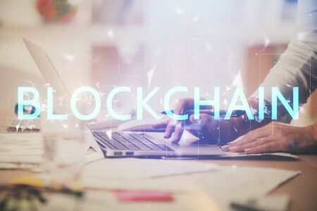 Double exposure of woman hands typing on computer and crypto market theme hologram drawing. Blockchain concept.の写真素材