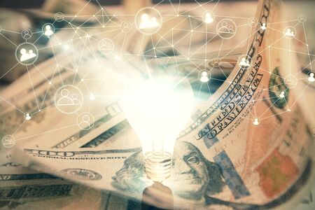 Double exposure of light bulb drawing over usa dollars bill background. Concept of idea.