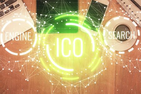 Double exposure of blockchain theme hologram over table with phone.の写真素材