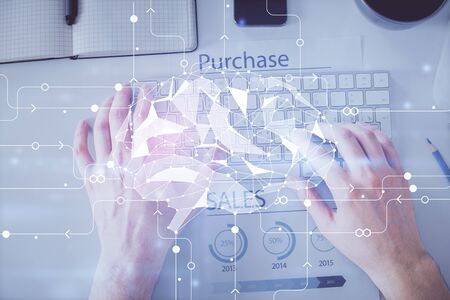 Double exposure of man's hands typing over computer keyboard and brain hologram drawing.