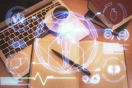 Education hologram drawings over computer on the desktop background. Top view. Multi exposure.の写真素材