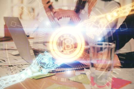 Double exposure of woman hands typing on computer and crypto market theme hologram drawing....