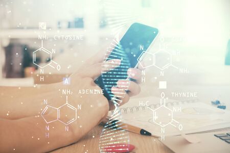 Double exposure of mans hands holding and using a phone and DNA drawing. Medical education concept.の写真素材