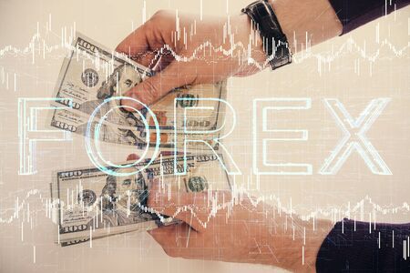 Multi exposure of financial graph drawing hologram and USA dollars bills and man hands. Analysis concept.の写真素材