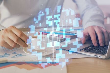 Double exposure of data internet theme hologram with man working on computer on background. Concept...