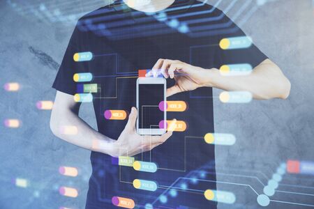 Double exposure of mans hand holding and using a digital device and data theme hologram drawing. Technology concept.の写真素材