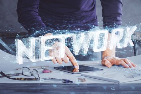 Double exposure of mans hand holding and using a digital device and data theme drawing. Technology concept.の写真素材