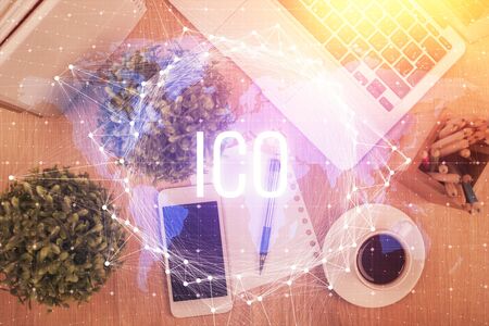 Double exposure of blockchain theme hologram over table with phone. Top view. Crypto technology...