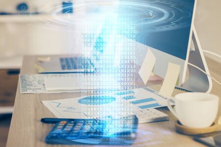 Double exposure of desktop computer and technology theme hologram. Concept of software development.