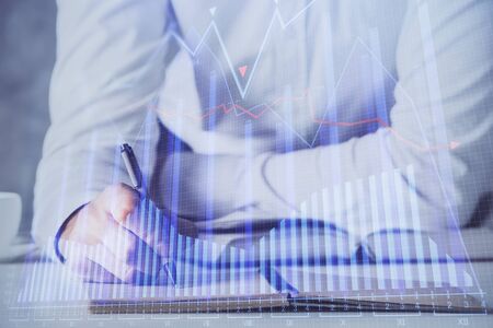 Financial trading chart multi exposure with man desktop background. Concept of success.の写真素材