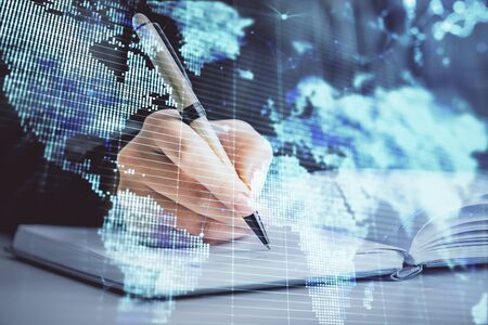 International business hologram over hands taking notes background. Concept of success. Multi exposureの写真素材