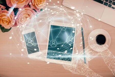Double exposure of social network theme drawing over table with phone. Top view. People connecting concept.の写真素材