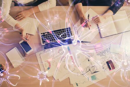 Double exposure of woman hands working on computer and neuron hologram drawing. Top View. Science concept.の写真素材