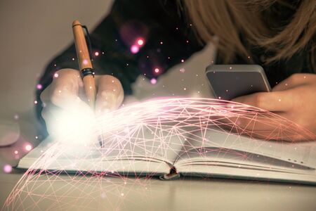 Double exposure of woman hands typing on computer and social network theme hologram drawing. People...
