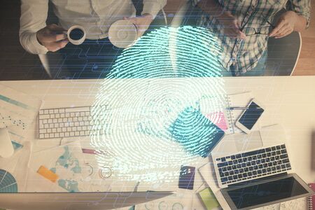Double exposure of man and woman working together and fingerprint drawing. Computer background. Top View. Security concept.の写真素材