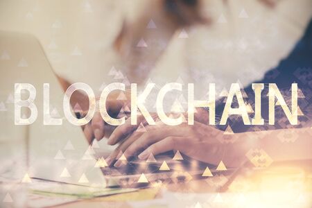 Double exposure of woman hands typing on computer and crypto market theme hologram drawing. Blockchain concept.の写真素材