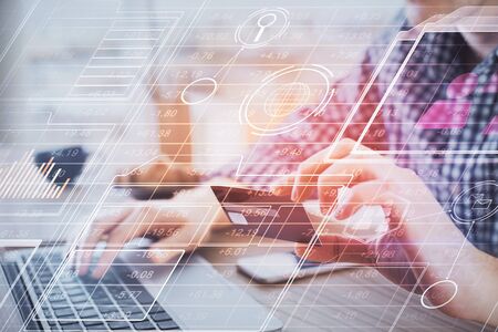 Double exposure of man hands holding a credit card and data theme drawing. E-commerce and technology...