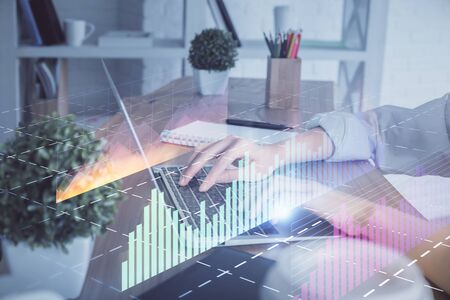 Double exposure of woman hands typing on computer and forex chart hologram drawing. Stock market invest concept.の写真素材