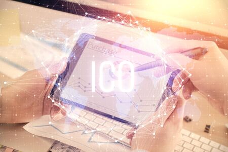 Double exposure of mans hands holding and using a phone and crypto currency blockchain theme...