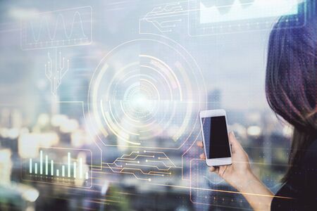 Double exposure of technology sketch hologram and woman holding and using a mobile device.の写真素材