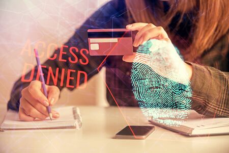 Multi exposure of woman on-line shopping holding a credit card and finger print drawing. Security concept.の写真素材