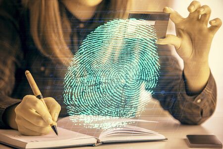Multi exposure of woman on-line shopping holding a credit card and finger print drawing. Security concept.の写真素材