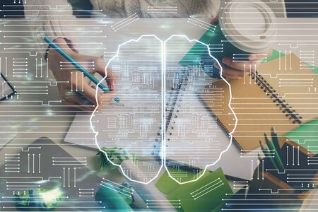 Multi exposure of writing hand on background with brain hologram. Concept of self learning.の写真素材
