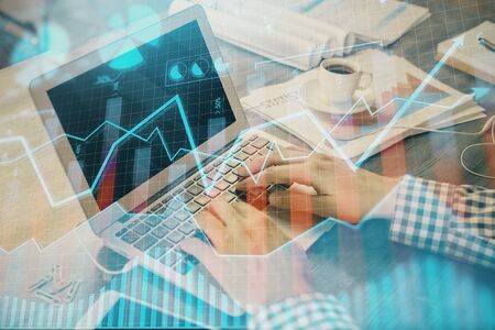 Double exposure of forex graph with man working on computer on background. Concept of market analysis.の写真素材