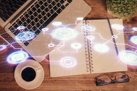 Social network hologram drawings over computer on the desktop background. Top view. Double exposure.の写真素材