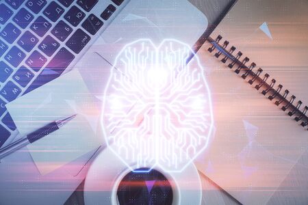 Double exposure of brain drawing hologram over topview work table background with computer. Concept...
