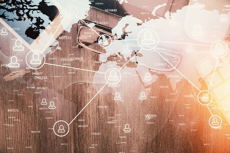 Double exposure of social network theme drawing over table with phone. Top view. People connecting concept.の写真素材