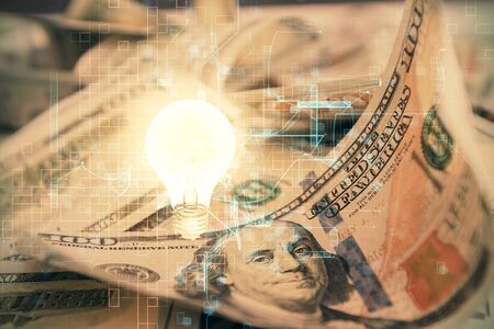 Double exposure of light bulb drawing over usa dollars bill background. Concept of idea.の写真素材