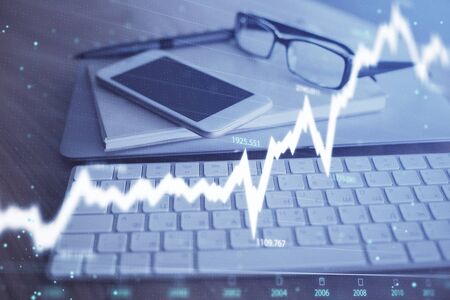 Double exposure of forex chart drawing and cell phone background. Concept of financial tradingの写真素材