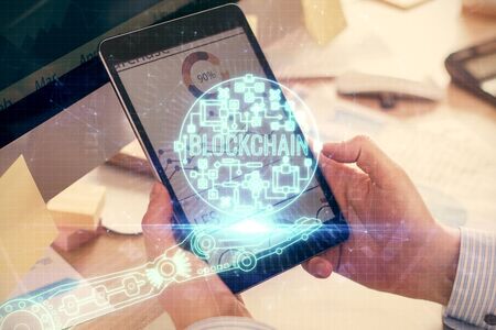 Double exposure of mans hands holding and using a phone and crypto currency blockchain theme drawing.の写真素材