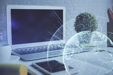 Computer on desktop with social network hologram. Multi exposure. Concept of international people connections.の写真素材