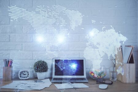 Computer on desktop with social network hologram. Multi exposure. Concept of international people connections.の写真素材