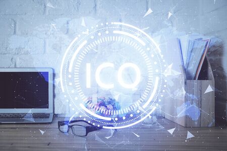 Multi exposure of blockchain and crypto economy theme hologram and table with computer background. Concept of bitcoin cryptocurrency.の写真素材