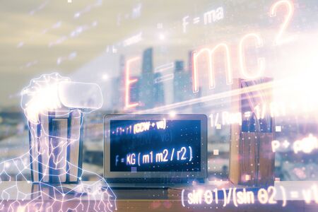 Desktop computer background and formula hologram writing. Double exposure. Education concept.の写真素材