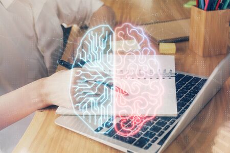 Multi exposure of writing hand on background with brain hologram. Concept of self learning.の写真素材